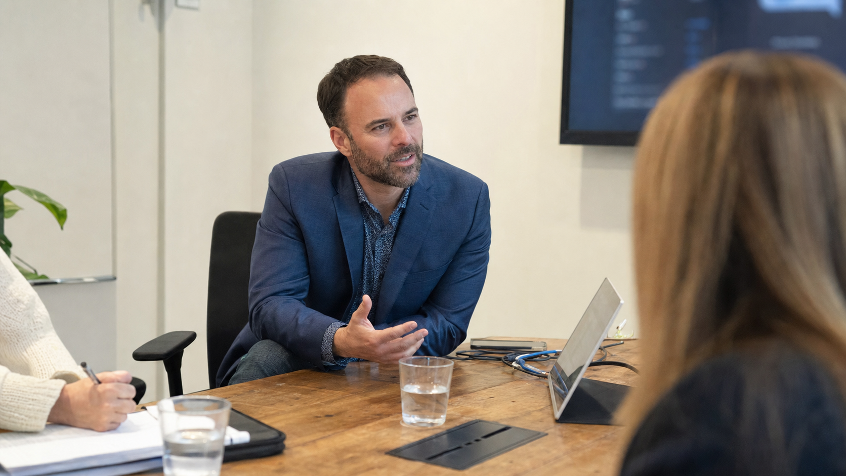 Brad Costanzo advising clients around a conference table
